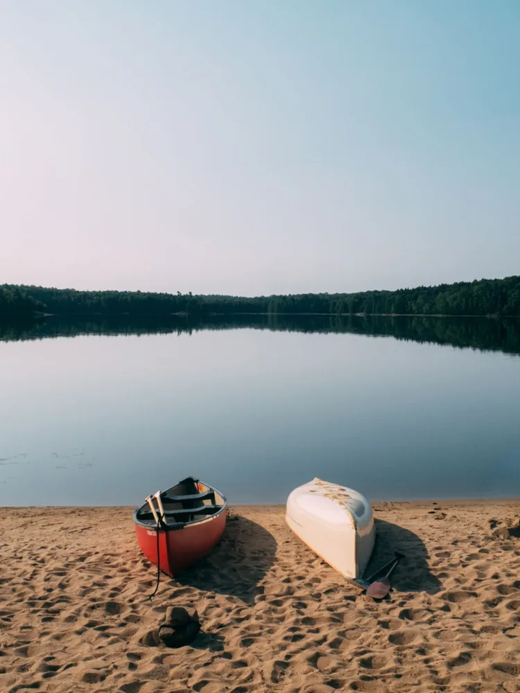 Boats on a beach in Kawartha Lakes